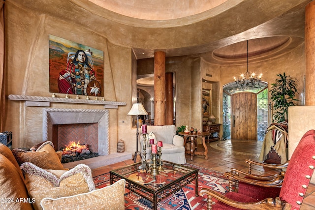 living room featuring an inviting chandelier, tile patterned floors, a high end fireplace, and a high ceiling