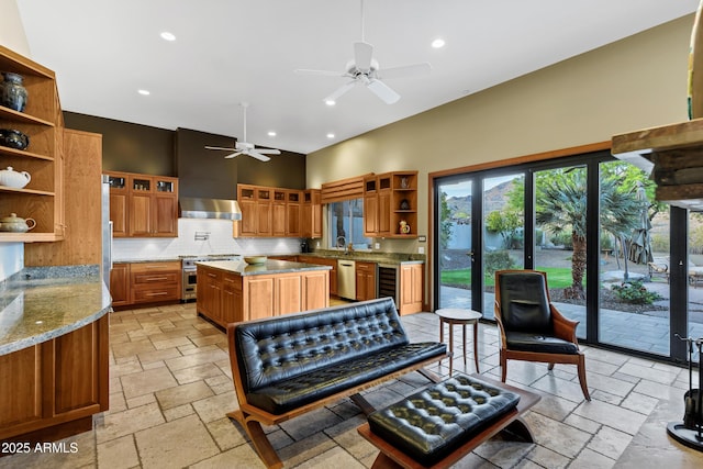 kitchen featuring ventilation hood, stone tile floors, open shelves, and stainless steel appliances