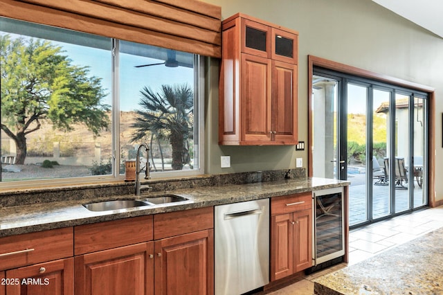 kitchen featuring brown cabinetry, wine cooler, stainless steel dishwasher, and a sink