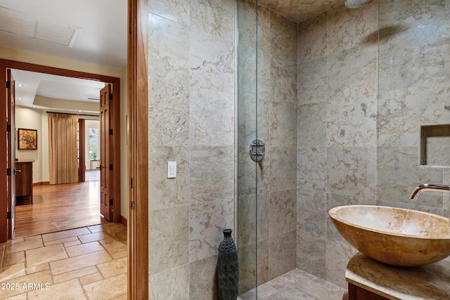 bathroom with vanity, visible vents, walk in shower, and stone tile flooring