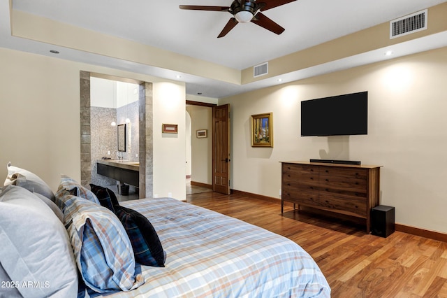 bedroom featuring visible vents, baseboards, recessed lighting, and wood finished floors