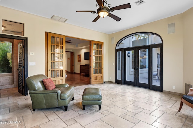 foyer entrance featuring visible vents, ceiling fan, plenty of natural light, and baseboards