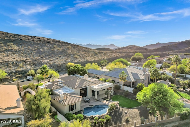 birds eye view of property with a mountain view