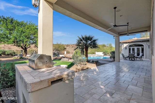 view of patio / terrace featuring an outdoor pool, french doors, ceiling fan, and area for grilling