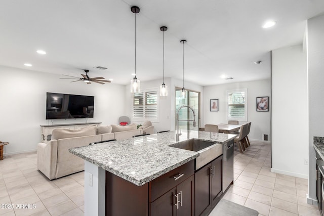 kitchen with a sink, a healthy amount of sunlight, a ceiling fan, and dishwasher