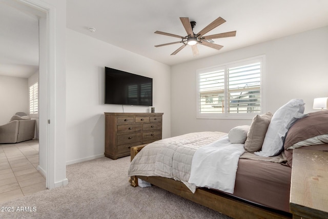 tiled bedroom featuring multiple windows, ceiling fan, baseboards, and carpet floors