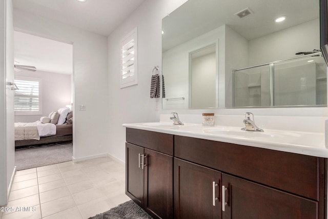 bathroom with a sink, visible vents, a shower with shower door, and ensuite bathroom