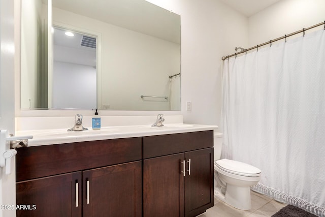 bathroom featuring visible vents, toilet, a sink, tile patterned flooring, and double vanity