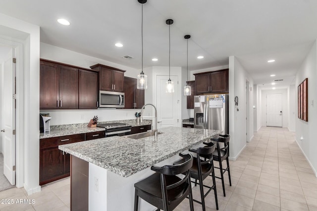 kitchen with visible vents, dark brown cabinets, recessed lighting, stainless steel appliances, and a sink