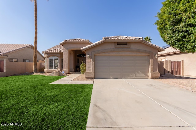 mediterranean / spanish home with a garage and a front lawn