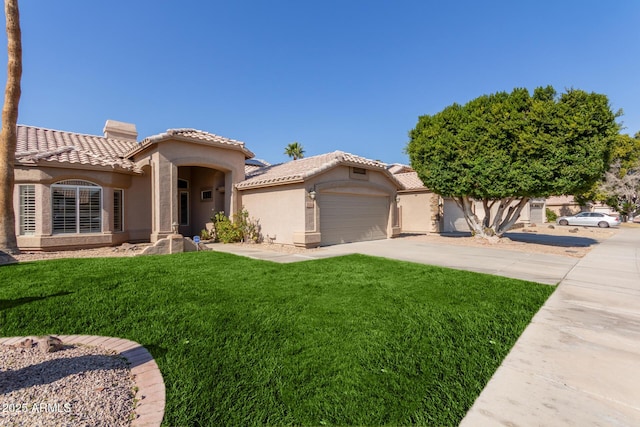 mediterranean / spanish-style house featuring a garage and a front yard