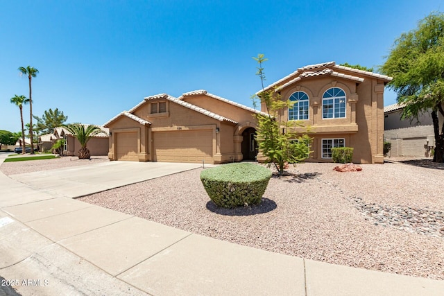 mediterranean / spanish-style house featuring a garage, a tile roof, driveway, and stucco siding