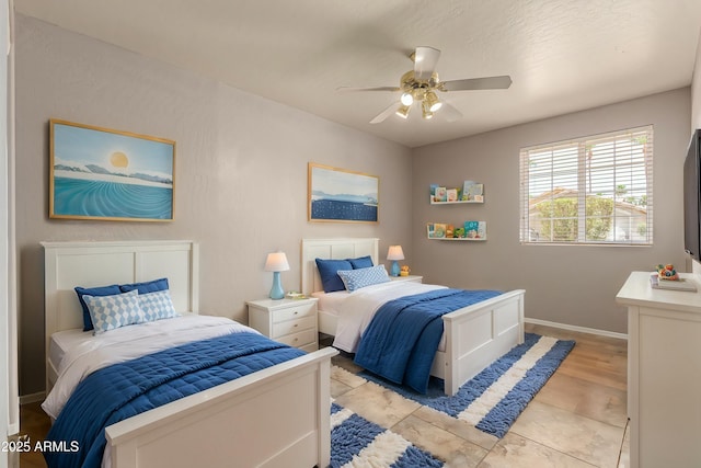 bedroom with baseboards and a ceiling fan