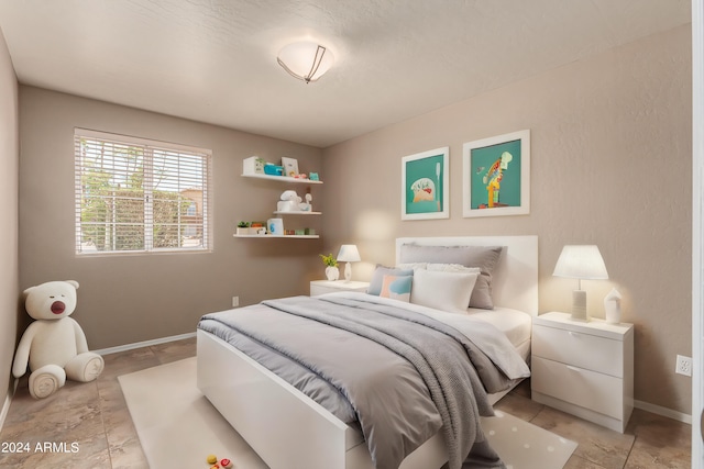 bedroom featuring baseboards