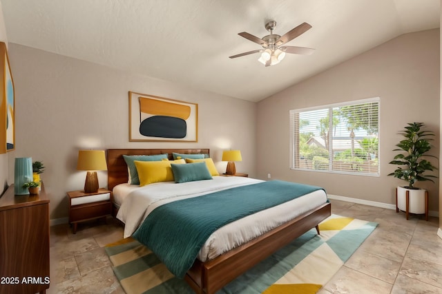 bedroom featuring ceiling fan, baseboards, and vaulted ceiling