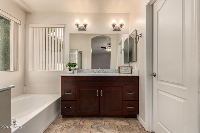 bathroom featuring a shower, a garden tub, and vanity