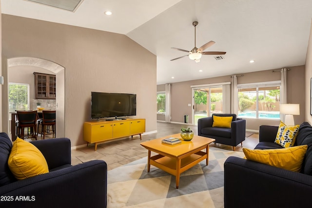 living room featuring lofted ceiling, visible vents, baseboards, and recessed lighting