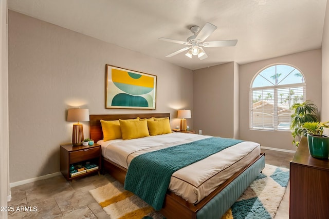 bedroom featuring a ceiling fan and baseboards