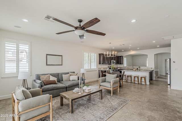 4067 S White Dr, Chandler, AZ 85249 - living room with arched walkways, ceiling fan, recessed lighting, baseboards, and a chandelier