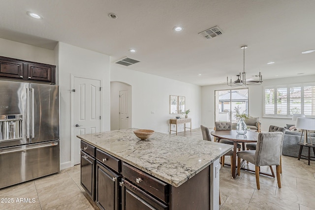4067 S White Dr, Chandler, AZ 85249 - kitchen featuring high quality fridge, open floor plan, arched walkways, recessed lighting, and light stone counters