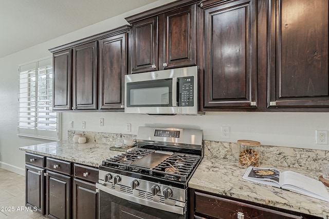 4067 S White Dr, Chandler, AZ 85249 - kitchen with appliances with stainless steel finishes, baseboards, light stone counters, and dark brown cabinets