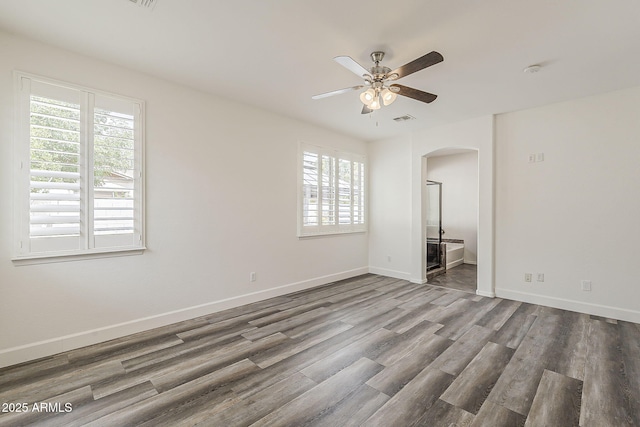 4067 S White Dr, Chandler, AZ 85249 - unfurnished room with arched walkways, wood finished floors, ceiling fan, and baseboards