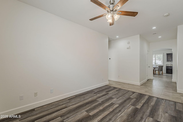 4067 S White Dr, Chandler, AZ 85249 - unfurnished room with arched walkways, ceiling fan, wood finished floors, recessed lighting, and baseboards