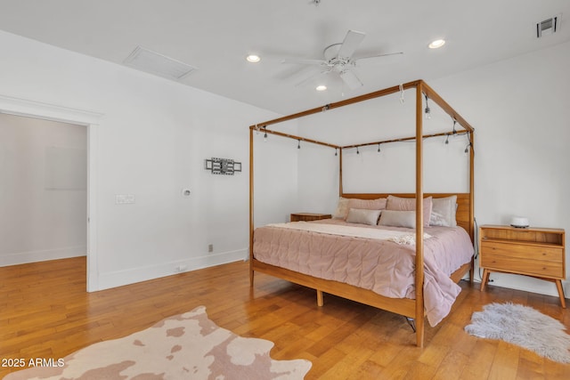 bedroom featuring attic access, baseboards, visible vents, hardwood / wood-style floors, and recessed lighting