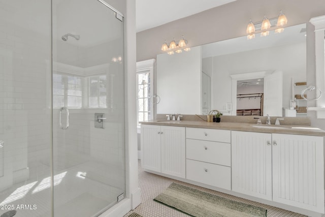 full bath with a stall shower, tile patterned flooring, a sink, and double vanity