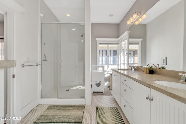 bathroom with tile patterned flooring, a sink, and a shower stall