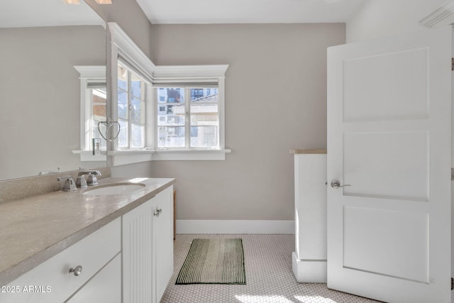 bathroom with tile patterned flooring, vanity, and baseboards