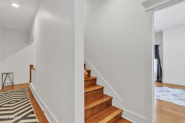 stairs with baseboards and wood finished floors