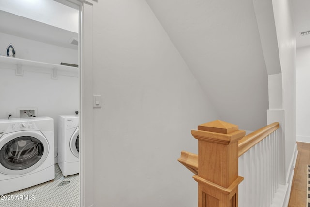 laundry area with laundry area, washing machine and dryer, visible vents, and baseboards