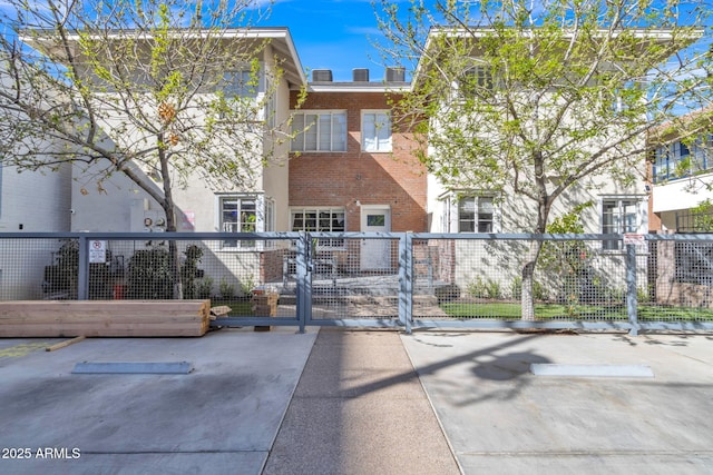 surrounding community with a fenced front yard and a gate