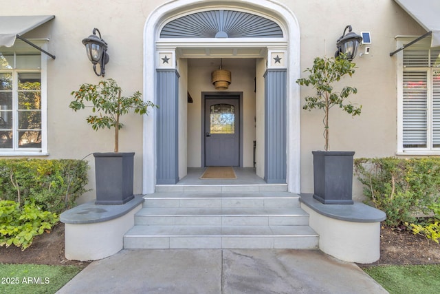 property entrance featuring stucco siding