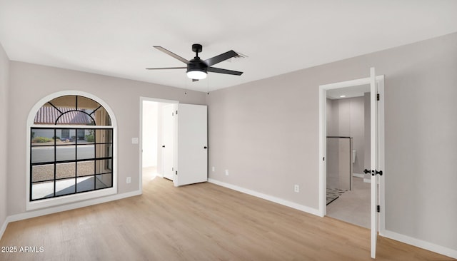 unfurnished bedroom with light wood-type flooring, a ceiling fan, and baseboards