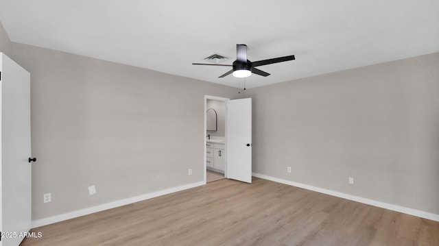 unfurnished bedroom with ensuite bathroom, light wood-style flooring, visible vents, a ceiling fan, and baseboards