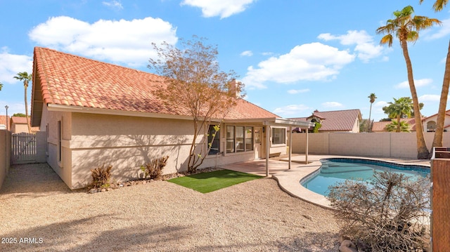 view of swimming pool featuring a patio area, a fenced backyard, and a fenced in pool