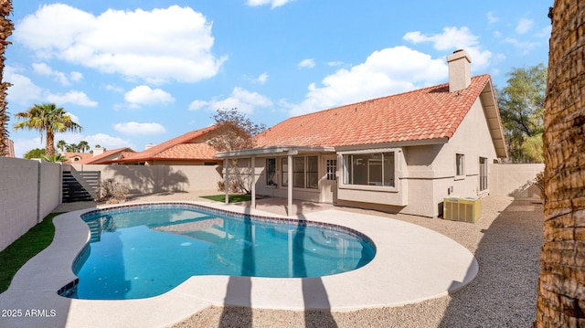 view of swimming pool featuring central air condition unit, a fenced backyard, a fenced in pool, and a patio