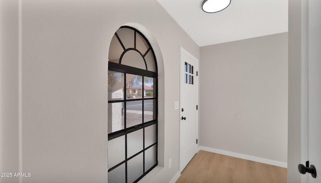 entryway with light wood-type flooring and baseboards