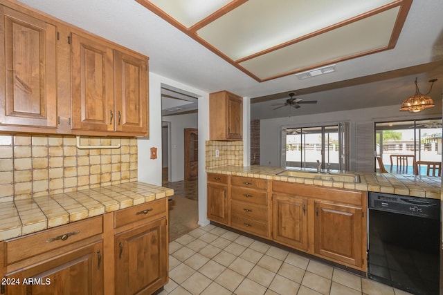 kitchen featuring black dishwasher, tile countertops, kitchen peninsula, decorative backsplash, and ceiling fan