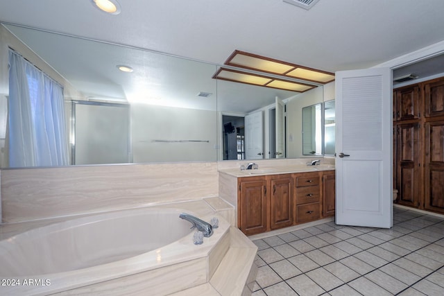 bathroom featuring vanity, independent shower and bath, and tile patterned floors