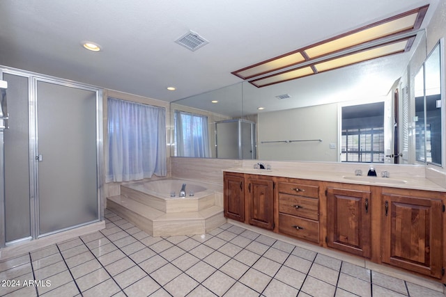 bathroom featuring vanity, a healthy amount of sunlight, tile patterned floors, and shower with separate bathtub