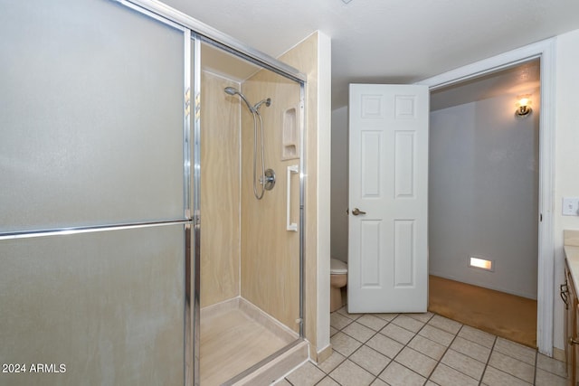 bathroom featuring vanity, toilet, tile patterned floors, and walk in shower