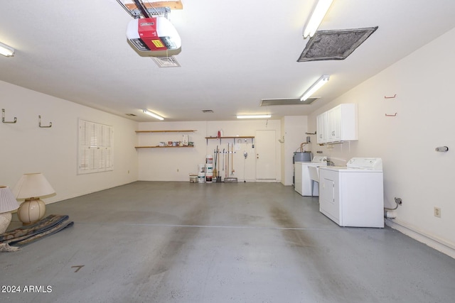 garage featuring a garage door opener and washer and dryer