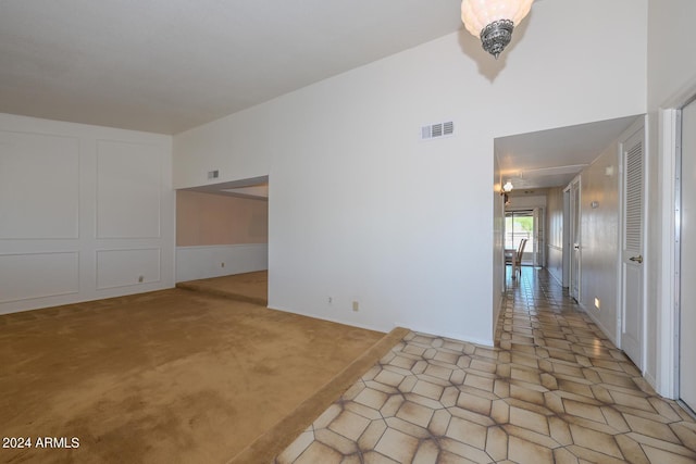 unfurnished room with light carpet