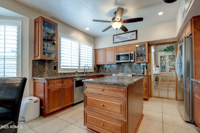 kitchen featuring backsplash, stainless steel appliances, and light tile patterned floors