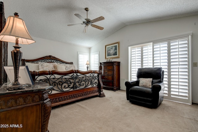 carpeted bedroom with a ceiling fan, vaulted ceiling, and a textured ceiling