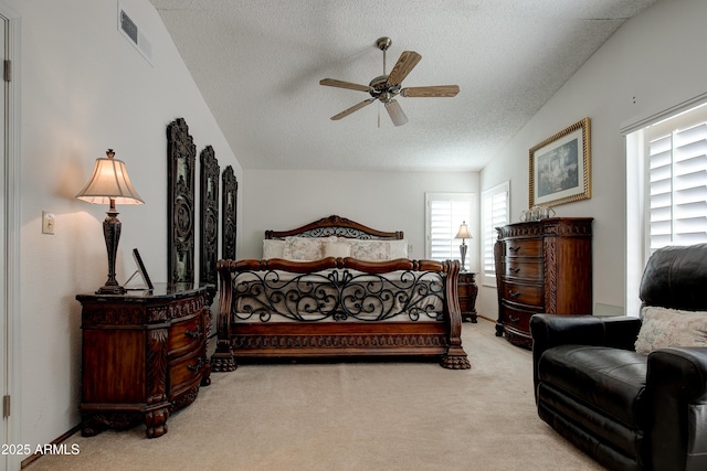 carpeted bedroom with ceiling fan, a textured ceiling, and visible vents