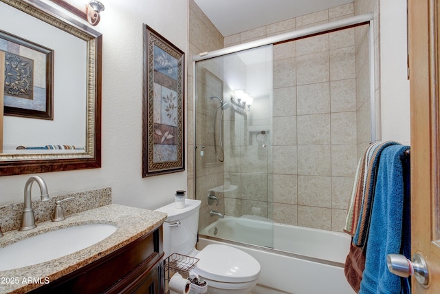 full bath featuring toilet, enclosed tub / shower combo, and vanity